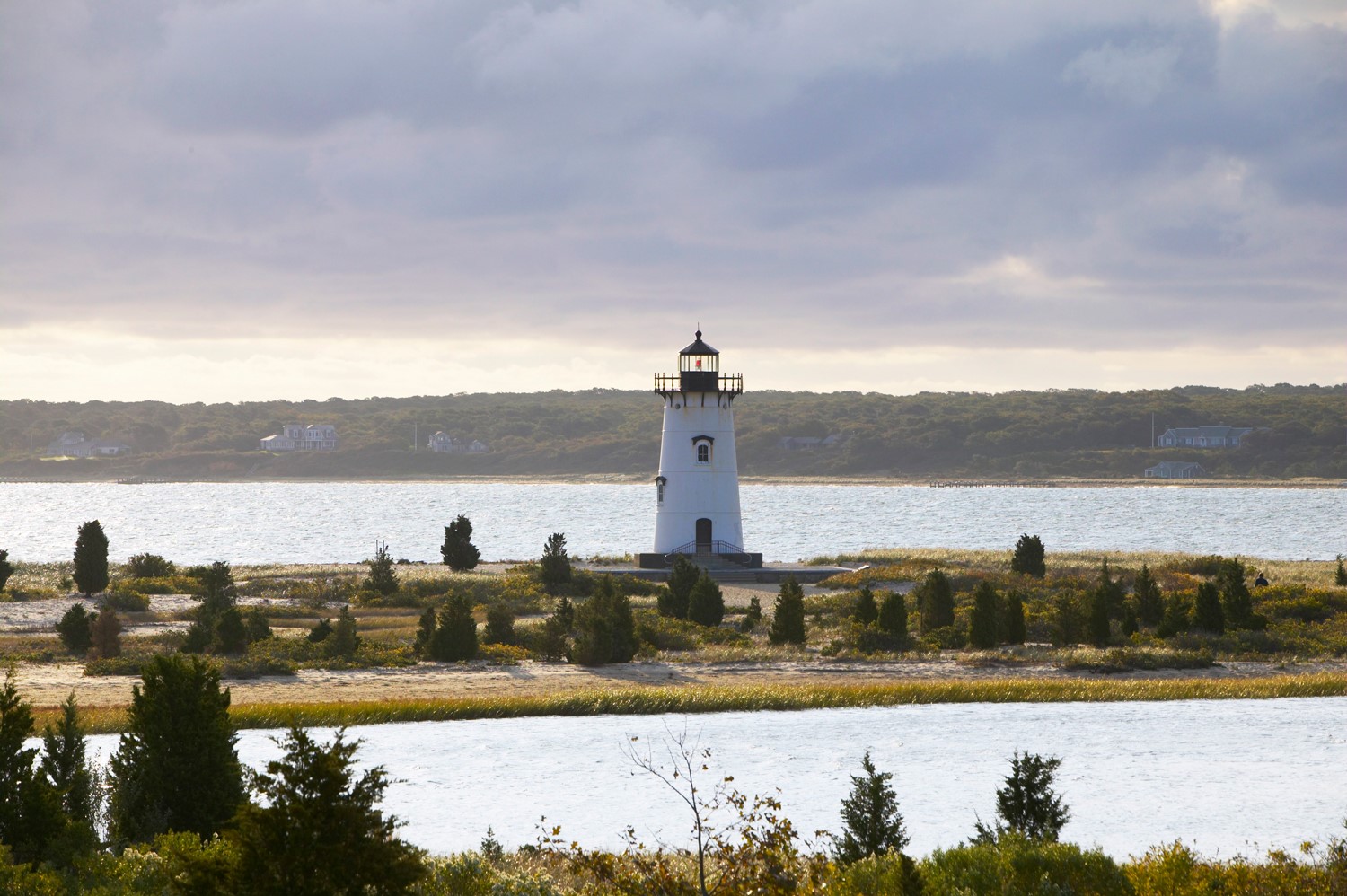 Lighthouse by coastal inlet