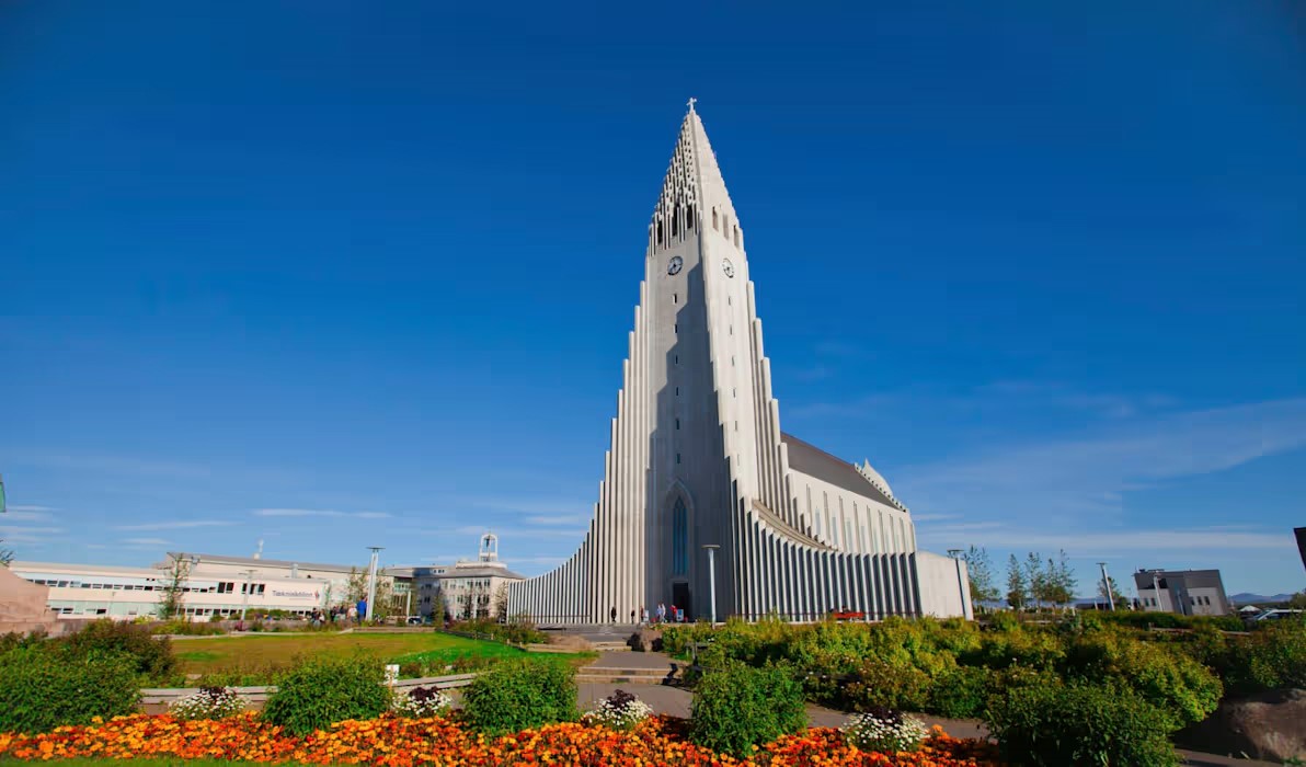 Tall white church with a pointed tower