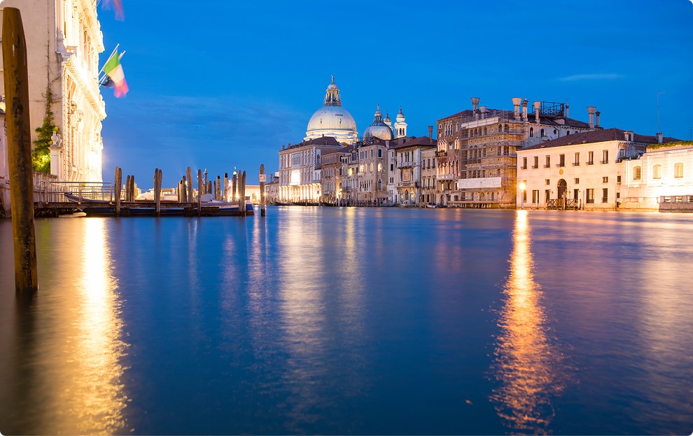 Canal with historic buildings at dusk